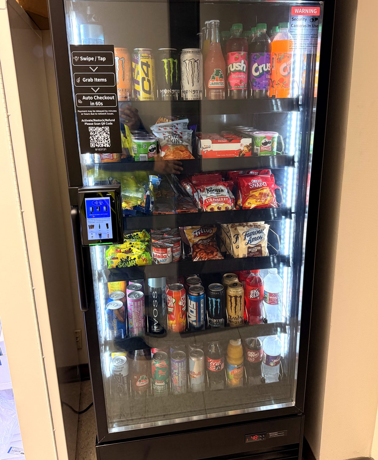 AI smart cooler with a tap-to-pay kiosk and swipe, grab, auto-checkout instructions